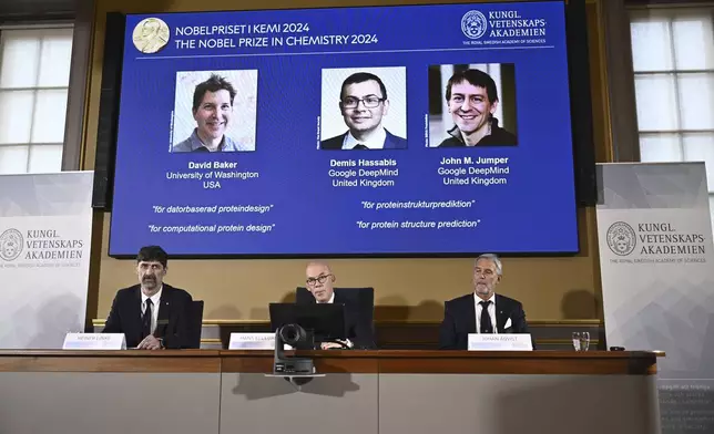 Johan Åqvist, member of the Nobel Committee for Chemistry, Hans Ellegren, Permanent Secretary and Heiner Linke, Chairman of the Nobel Committee for Chemistry award this years Nobel Prize in Chemistry to David Baker, Demis Hassabis, and John M Jumper at the Royal Swedish Academy of Sciences, in Stockholm, Sweden, Wednesday, Oct. 9, 2024. (Christine Olsson/TT News Agency via AP)