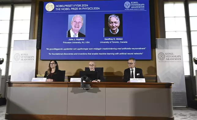 John Hopfield and Geoffrey Hinton, seen in picture, are awarded this year's Nobel Prize in Physics, which is announced at a press conference by Hans Ellergren, center, permanent secretary at the Swedish Academy of Sciences in Stockholm, Sweden Tuesday Oct. 8, 2024. (Christine Olsson/TT News Agency via AP)