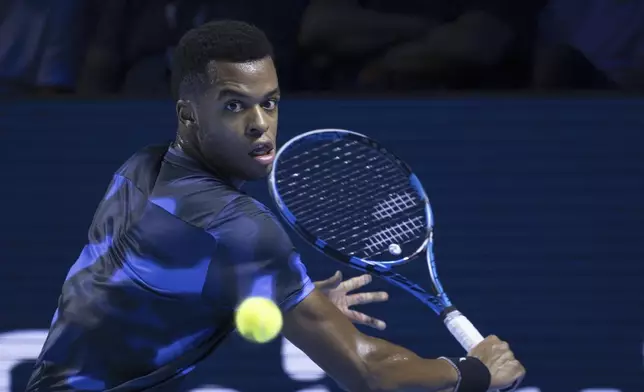 France's Giovanni Mpetshi Perricard returns a ball to United States's Ben Shelton during the final match at the Swiss Indoors tennis tournament at the St. Jakobshalle in Basel, Switzerland, Sunday, Oct. 27, 2024. (Georgios Kefalas/Keystone via AP)