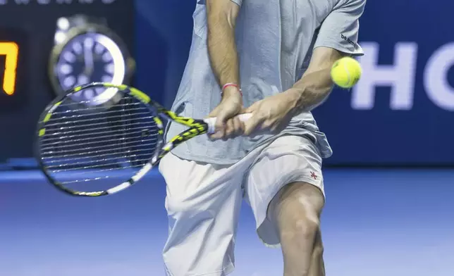 France's Adrian Mannarino returns a ball to Switzerland's Stan Wawrinka during a first round match at the Swiss Indoors tennis tournament in Basel, Switzerland, Wednesday, Oct. 23, 2024. (Georgios Kefalas/Keystone via AP)