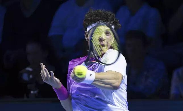 United States's Ben Shelton returns a ball to France's Giovanni Mpetshi Perricard during the final match at the Swiss Indoors tennis tournament at the St. Jakobshalle in Basel, Switzerland, Sunday, Oct. 27, 2024. (Georgios Kefalas/Keystone via AP)