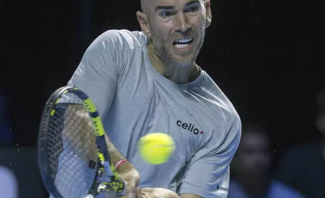 France's Adrian Mannarino returns a ball to Switzerland's Stan Wawrinka during a first round match at the Swiss Indoors tennis tournament in Basel, Switzerland, Wednesday, Oct. 23, 2024. (Georgios Kefalas/Keystone via AP)