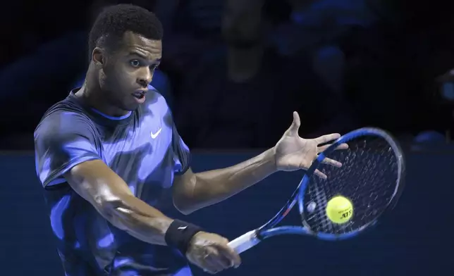 France's Giovanni Mpetshi Perricard returns a ball to United States's Ben Shelton during the final match at the Swiss Indoors tennis tournament at the St. Jakobshalle in Basel, Switzerland, Sunday, Oct. 27, 2024. (Georgios Kefalas/Keystone via AP)