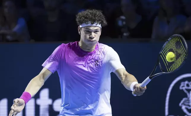 United States's Ben Shelton returns a ball to France's Giovanni Mpetshi Perricard during the final match at the Swiss Indoors tennis tournament at the St. Jakobshalle in Basel, Switzerland, Sunday, Oct. 27, 2024. (Georgios Kefalas/Keystone via AP)