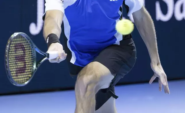 Greece's Stefanos Tsitsipas returns a shot to France's Arthur Fils during their quarter final match of the Swiss Indoors Basel tennis tournament, at the St. Jakobshalle in Basel, Switzerland, Friday, Oct. 25, 2024. (Georgios Kefalas/Keystone via AP)