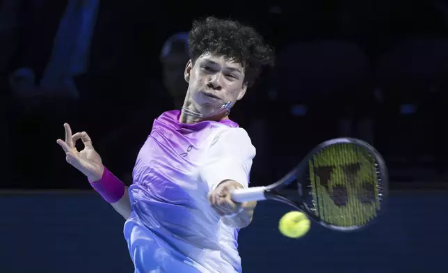 Ben Shelton of the U.S. returns a ball to Russia's Andrey Rublev during their quarter final match at the Swiss Indoors tennis tournament at the St. Jakobshalle in Basel, Switzerland, Friday, Oct. 25, 2024. (Georgios Kefalas/Keystone via AP)