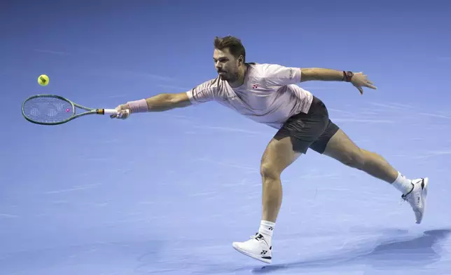 Switzerland's Stan Wawrinka returns a ball to France's Adrian Mannarino during their first round match at the Swiss Indoors tennis tournament at the St. Jakobshalle in Basel, Switzerland, Wednesday, Oct. 23, 2024. (Georgios Kefalas/Keystone via AP)