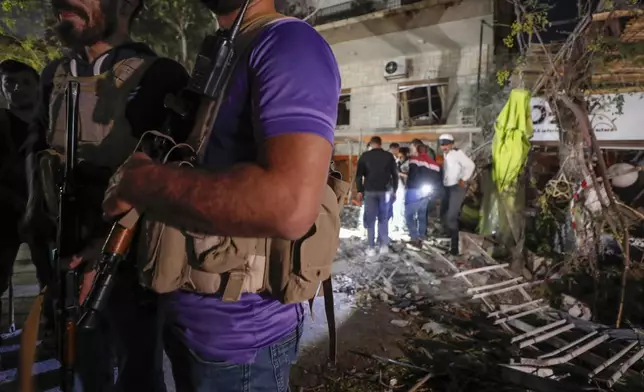 Police stand guard at the site of an apparent Israeli airstrike in Damascus, Syria, Wednesday, Oct. 2, 2024. (AP Photo/Omar Sanadiki)