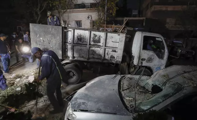 Workers clean at the site of an apparent Israeli airstrike in Damascus, Syria, Wednesday, Oct. 2, 2024. (AP Photo/Omar Sanadiki)