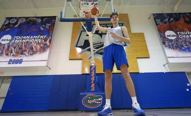 Olivier Rioux, 7-foot-9 NCAA college basketball player at Florida, poses for a photo after practice, Friday, Oct. 18, 2024, in Gainesville, Fla. (AP Photo/John Raoux)