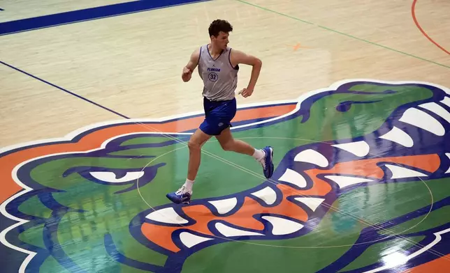 Olivier Rioux, 7-foot-9 NCAA college basketball player at Florida, runs the court at the team's practice, Friday, Oct. 18, 2024, in Gainesville, Fla. (AP Photo/John Raoux)