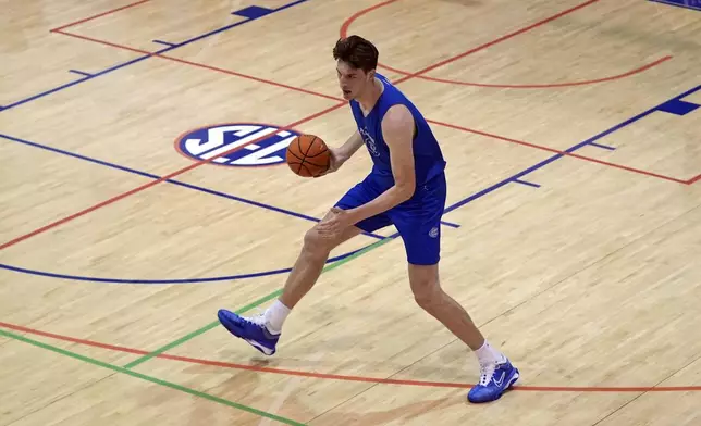 Olivier Rioux, 7-foot-9 NCAA college basketball player at Florida, moves the ball downcourt at the team's practice, Friday, Oct. 18, 2024, in Gainesville, Fla. (AP Photo/John Raoux)