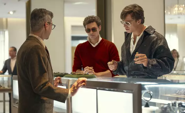 This image released by Netflix shows Cooper Koch as Erik Menendez, center, and Nicholas Chavez as Lyle Menendez, right, in a scene from "Monsters: The Lyle And Erik Menendez Story." (Miles Crist/Netflix via AP)