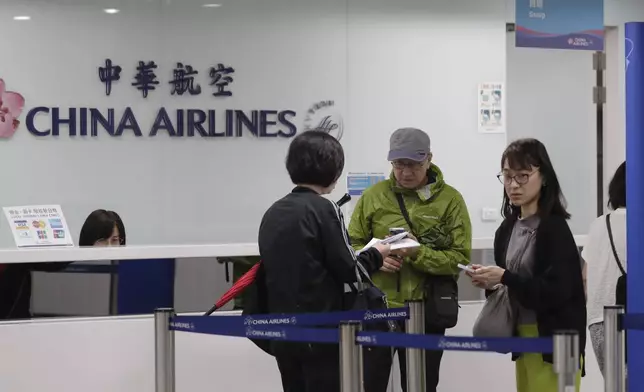 People went to airline counters at an airport to ask about canceled flights due to approaching Typhoon Krathon, in Kaohsiung, southern Taiwan, Wednesday, Oct. 2, 2024. (AP Photo/Chiang Ying-ying)