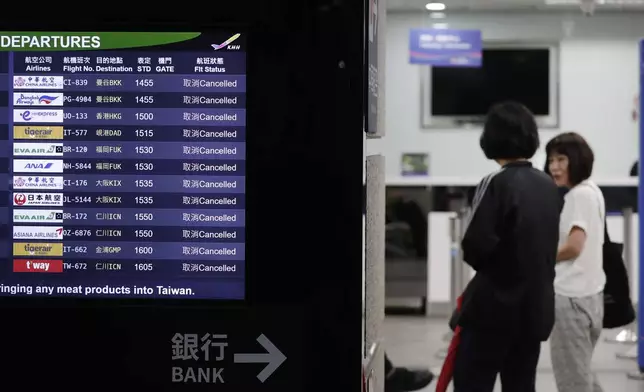 People went to airline counters to ask about canceled flights due to approaching Typhoon Krathon, in Kaohsiung, southern Taiwan, Wednesday, Oct. 2, 2024. (AP Photo/Chiang Ying-ying)