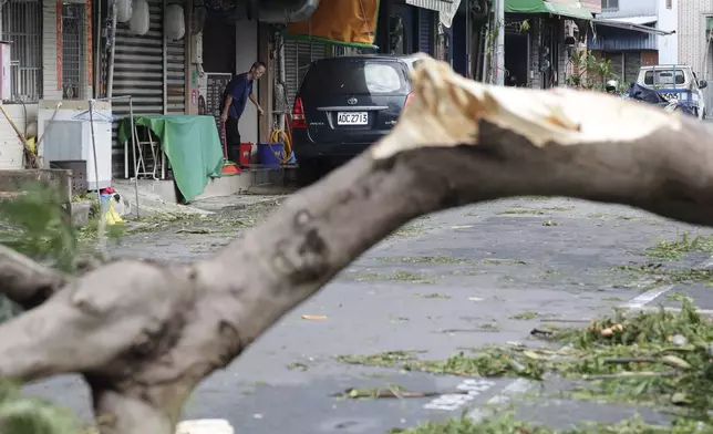 A man clears debris in the aftermath of Typhoon Krathon in Kaohsiung, southern Taiwan, Friday, Oct. 4, 2024. (AP Photo/Chiang Ying-ying)