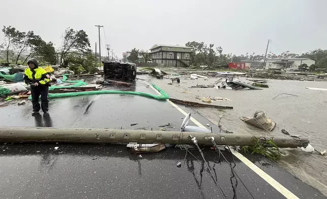 In this photo released by Hualien County Fire Department, police check an area destroyed by the wind from Typhoon Kong-rey in Hualien County, eastern Taiwan, Thursday, Oct. 31, 2024. (AP Photo/Hualien County Fire Department)