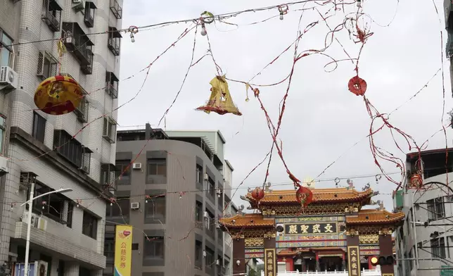 Lanterns destroyed by the wind of Typhoon Krathon, hang outside a temple in Kaohsiung, southern Taiwan, Friday, Oct. 4, 2024. (AP Photo/Chiang Ying-ying)