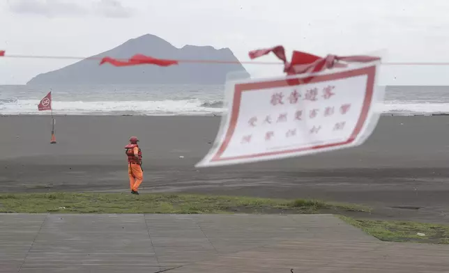 A soldier of Coast Guard Administration guards on the beach as Typhoon Krathon approaches to Taiwan in Yilan County, eastern coast of Taiwan, Tuesday, Oct. 1, 2024. (AP Photo/Chiang Ying-ying)