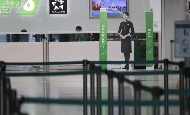 Airline staff work at the counter at a closed airport due to approaching Typhoon Krathon, in Kaohsiung, southern Taiwan, Wednesday, Oct. 2, 2024. (AP Photo/Chiang Ying-ying)