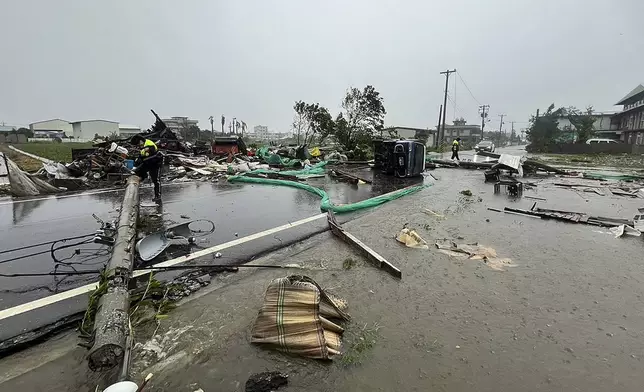 In this photo released by Hualien County Fire Department, police check an area destroyed by the wind from Typhoon Kong-rey in Hualien County, eastern Taiwan, Thursday, Oct. 31, 2024. (Hualien County Fire Department via AP)