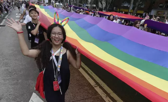 Participants revel through a street during the annual Taiwan LGBT Pride parade in Taipei, Taiwan, Saturday, Oct. 26, 2024. (AP Photo/Chiang Ying-ying)