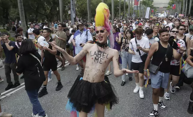 Participants revel through a street during the annual Taiwan LGBT Pride parade in Taipei, Taiwan, Saturday, Oct. 26, 2024. (AP Photo/Chiang Ying-ying)