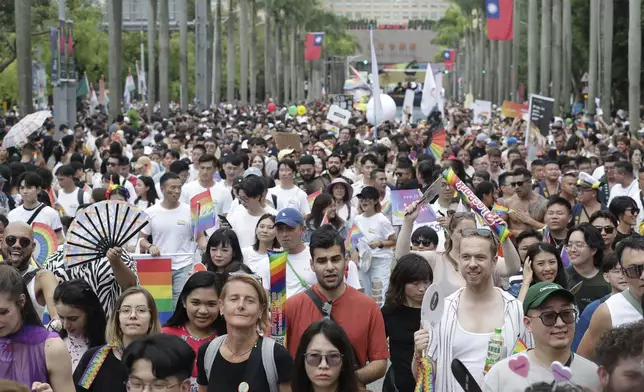 Participants revel through a street during the annual Taiwan LGBT Pride parade in Taipei, Taiwan, Saturday, Oct. 26, 2024. (AP Photo/Chiang Ying-ying)