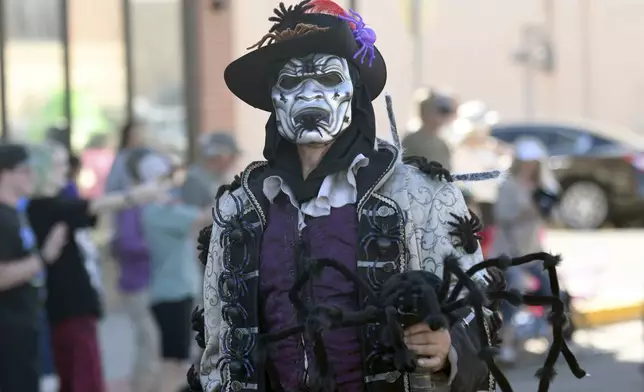 A man walks in the Tarantula Festival parade in La Junta, Colo., Saturday, Sept. 28, 2024. (AP Photo/Thomas Peipert)