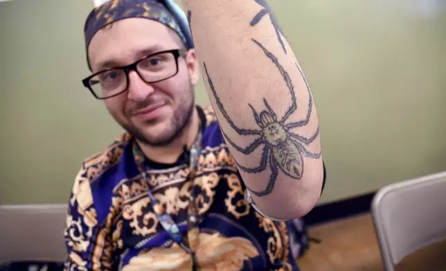 Goran Shikak, an arachnology graduate student at The University of Colorado Denver, shows off his spider tattoos during the Tarantula Festival in La Junta, Colo., Saturday, Sept. 28, 2024. (AP Photo/Thomas Peipert)