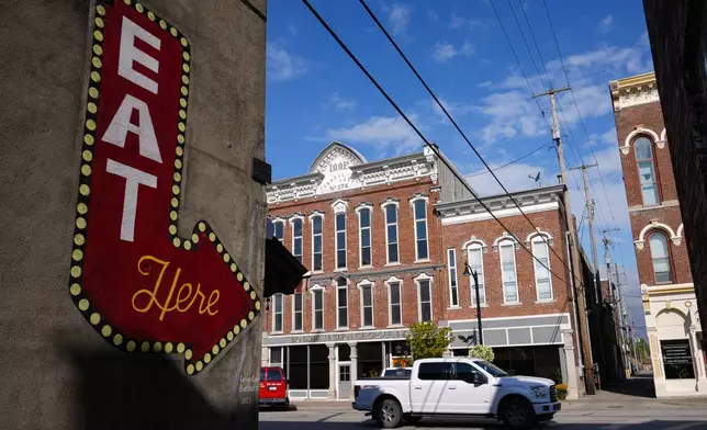 Signage for a restaurant located among some of the historic buildings on Main Street in the downtown area in Delphi, Ind., Tuesday, Oct. 1, 2024. (AP Photo/Michael Conroy)