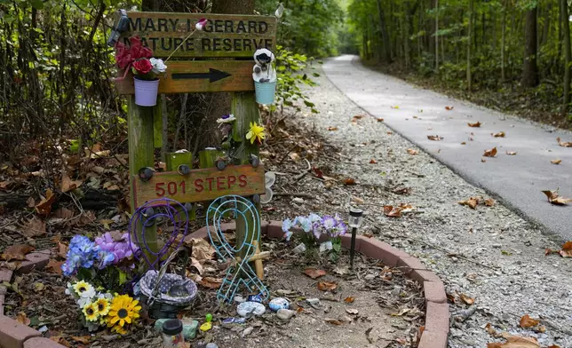 Decorated stones bearing the names of Abigail Williams and Liberty German, who were killed in February 2017, are placed at a memorial along the Monon High Bridge Trail in Delphi, Ind., Tuesday, Oct. 1, 2024. (AP Photo/Michael Conroy)