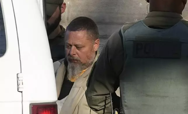 FILE - Officers escort Richard Allen out of the Carroll County courthouse following a hearing, Nov. 22, 2022, in Delphi, Ind. Allen, of Delphi, is scheduled to go on trail Oct. 14, 2024 for the slayings of two teenage girls, Liberty German, 14, and Abigail Williams, 13, who were killed while hiking in 2017 near their small community in northern Indiana hometown. (AP Photo/Darron Cummings, File)