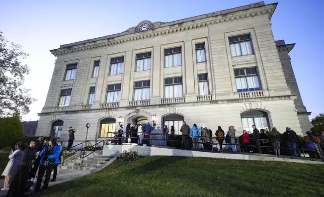 Spectators line up to enter the Carroll County Courthouse for the trail of Richard Allen, accused of the slayings of two teenage girls in 2017, is set to begin in Delphi, Ind., Friday, Oct. 18, 2024. (AP Photo/Michael Conroy)