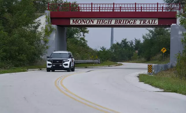 A Delphi Police Department vehicle drives under the Monon High Bridge Tail in Delphi, Ind., Tuesday, Oct. 1, 2024. (AP Photo/Michael Conroy)