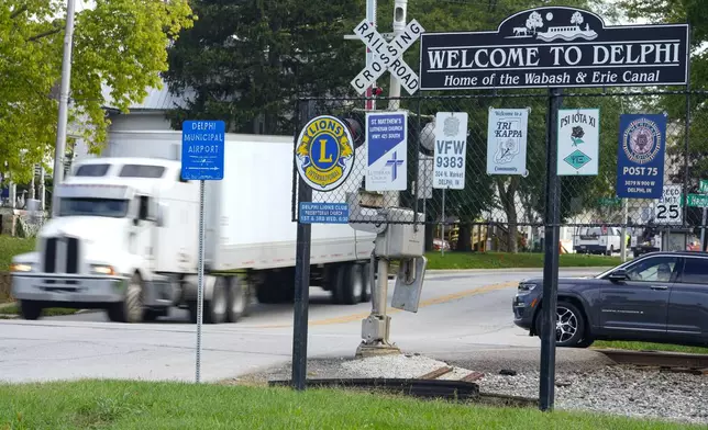 A semi-truck crosses a railroad crossing on the edge of town in Delphi, Ind., Tuesday, Oct. 1, 2024. (AP Photo/Michael Conroy)