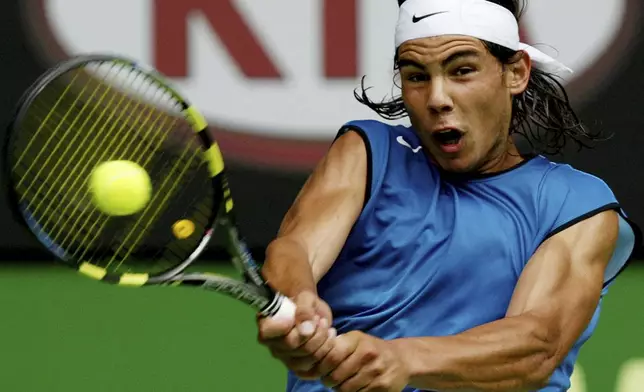 FILE - Spain's Rafael Nadal makes a backhand return during his second round win over Russia's Mikhail Youzhny at the Australian Open at Melbourne Park, Melbourne, Australia, Thursday, Jan. 20, 2005. (AP Photo/Rick Stevens, File)