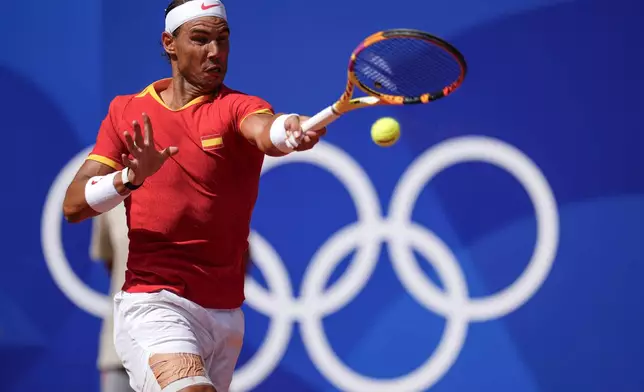 FILE - Rafael Nadal of Spain returns the ball against Marton Fucsovics of Hungary during the men's singles tennis competition, at the 2024 Summer Olympics, Sunday, July 28, 2024, in Paris, France. (AP Photo/Manu Fernandez, File)