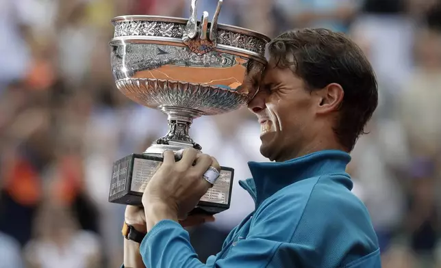 FILE - Spain's Rafael Nadal holds the trophy as he celebrates winning the men's final match of the French Open tennis tournament against Austria's Dominic Thiem at the Roland Garros stadium in Paris, France, Sunday, June 10, 2018. (AP Photo/Alessandra Tarantino, File)