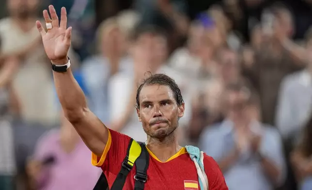 FILE - Rafael Nadal reacts waves after the men's doubles quarter-final tennis competition at the Roland Garros stadium, at the 2024 Summer Olympics, July 31, 2024, in Paris, France. (AP Photo/Manu Fernandez, file)