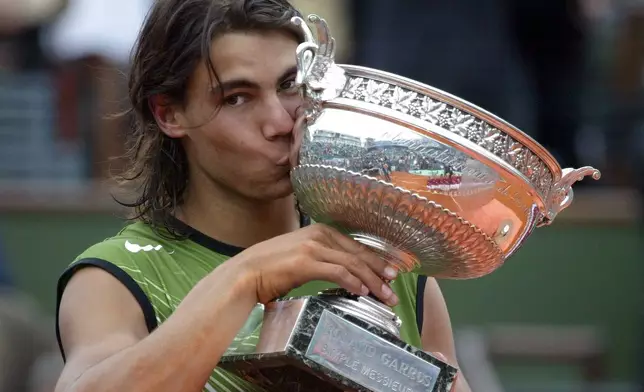 FILE - Spain's Rafael Nadal kisses the trophy after defeating Argentina's Mariano Puerta during their final of the French Open tennis tournament, at the Roland Garros stadium, Sunday, June 5, 2005 in Paris. (AP Photo/Lionel Cironneau, File)