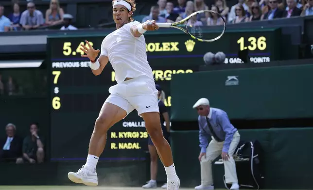 FILE - Rafael Nadal of Spain leaps as he plays a return to Nick Kyrgios of Australia during their men's singles match at the All England Lawn Tennis Championships in Wimbledon, London, Tuesday, July 1, 2014, as he has announced he will retire from tennis at age 38 following the Davis Cup finals in November. (AP Photo/Ben Curtis, File)