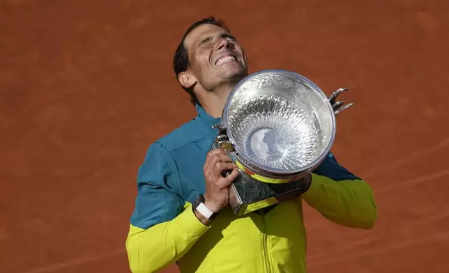 FILE - Spain's Rafael Nadal lifts the trophy after winning the final match against Norway's Casper Ruud in three sets, 6-3, 6-3, 6-0, at the French Open tennis tournament in Roland Garros stadium in Paris, France, Sunday, June 5, 2022, as he has announced he will retire from tennis at age 38 following the Davis Cup finals in November. (. (AP Photo/Christophe Ena, File)