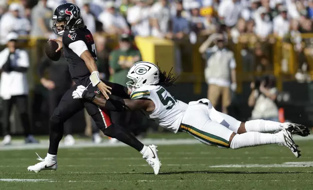 Houston Texans quarterback C.J. Stroud (7) tries to get past Green Bay Packers defensive end Rashan Gary (52) during the first half of an NFL football game, Sunday, Oct. 20, 2024, in Green Bay, Wis. (AP Photo/Matt Ludtke)