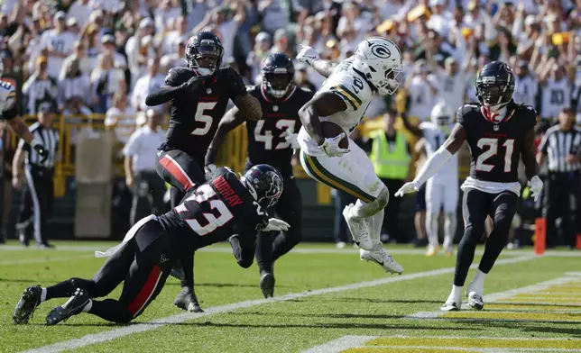 Green Bay Packers running back Josh Jacobs (8) scores a touchdown during the second half of an NFL football game against the Houston Texans, Sunday, Oct. 20, 2024, in Green Bay, Wis. (AP Photo/Matt Ludtke)