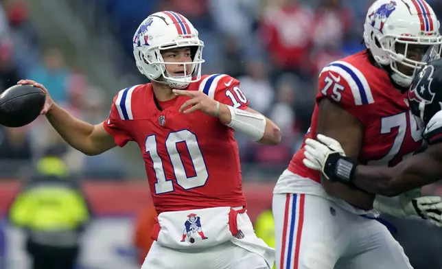 New England Patriots quarterback Drake Maye (10) looks to pass the ball as offensive tackle Demontrey Jacobs (75) defends during the second half of an NFL football game against the Houston Texans, Sunday, Oct. 13, 2024, in Foxborough, Mass. (AP Photo/Steven Senne)