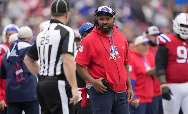 New England Patriots head coach Jerod Mayo, center right, talks with field judge Ryan Dickerson (25) during the first half of an NFL football game against the Houston Texans, Sunday, Oct. 13, 2024, in Foxborough, Mass. (AP Photo/Charles Krupa)