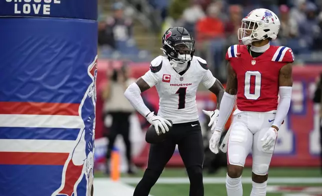 Houston Texans wide receiver Stefon Diggs (1) reacts after his touchdown behind New England Patriots cornerback Christian Gonzalez (0) during the second half of an NFL football game, Sunday, Oct. 13, 2024, in Foxborough, Mass. (AP Photo/Charles Krupa)