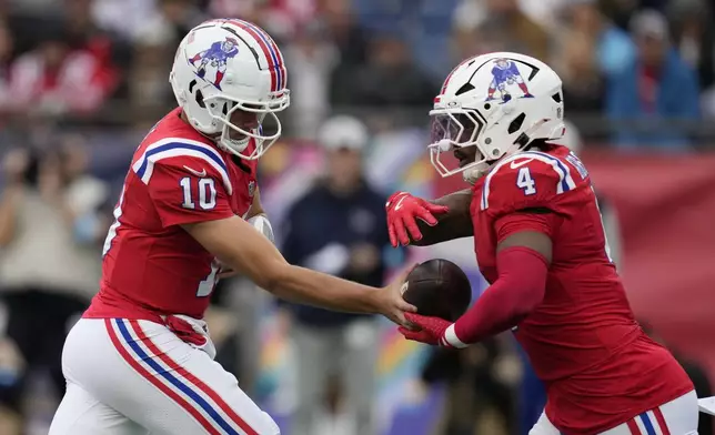 New England Patriots quarterback Drake Maye (10) hands off to running back Antonio Gibson (4) during the first half of an NFL football game against the Houston Texans, Sunday, Oct. 13, 2024, in Foxborough, Mass. (AP Photo/Charles Krupa)