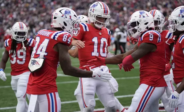 New England Patriots wide receiver Kayshon Boutte (9) celebrates after his touchdown reception with quarterback Drake Maye (10) and wide receiver Kendrick Bourne (84) during the first half of an NFL football game against the Houston Texans, Sunday, Oct. 13, 2024, in Foxborough, Mass. (AP Photo/Charles Krupa)